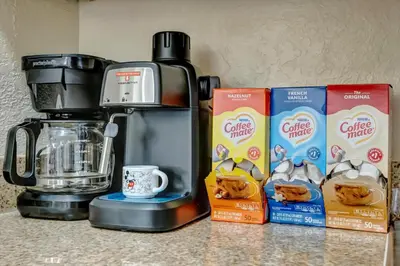 a counter with a coffee maker and boxes of cereal at 10 Mins To Disney NO FEES Heated Pool & Hot Tub in Orlando