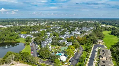 an aerial view of a resort with a lake and houses at Modern 2BR Stay in Prime Location in Orlando