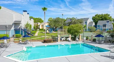 a swimming pool with a playground and a resort at Modern 2BR Stay in Prime Location in Orlando