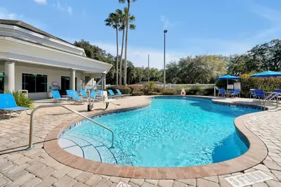 a swimming pool with blue lounge chairs around it at Free Shuttle Mickey Universal Epic SeaWorld in Orlando