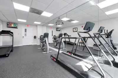 a gym with treadmills and machines in a room at Free Shuttle Mickey Universal Epic SeaWorld in Orlando