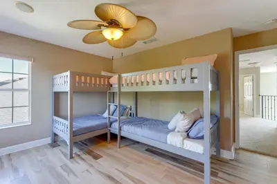 two bunk beds in a room with a ceiling fan at Fish and Boat Lake Toho Family Gem Near Theme Parks in Kissimmee
