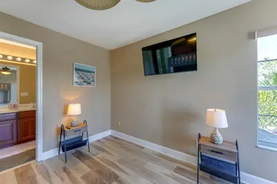 a bathroom with two tables and a television on the wall at Fish and Boat Lake Toho Family Gem Near Theme Parks in Kissimmee