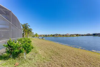 a building next to a body of water at Fish and Boat Lake Toho Family Gem Near Theme Parks in Kissimmee