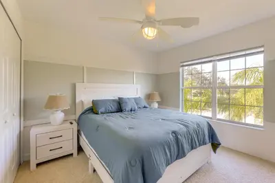 a bedroom with a bed and a ceiling fan at Fish and Boat Lake Toho Family Gem Near Theme Parks in Kissimmee