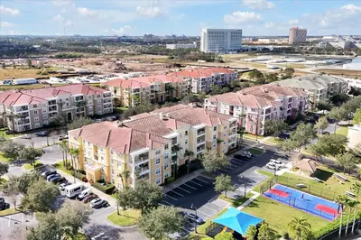 an aerial view of an apartment complex with a parking lot at Epic Universe Condo - Vista Cay - 2028 in Orlando