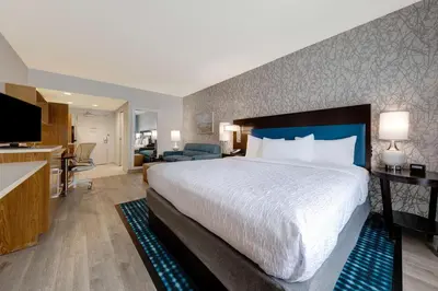 a hotel room with a large bed and a kitchen at Home2 Suites by Hilton Orlando International Drive South - Free Shuttle to Theme Parks in Orlando