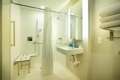 a white bathroom with a sink and a shower at Holiday Inn Express & Suites S Lake Buena Vista by IHG in Kissimmee