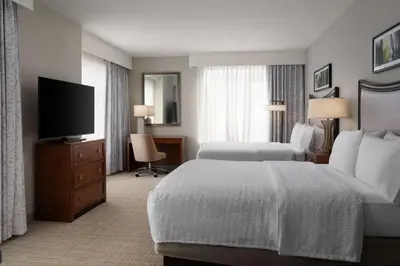a hotel room with a bed and a flat screen tv at Hampton Inn & Suites Orlando/Downtown South - Medical Center in Orlando