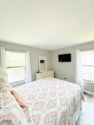 a bedroom with a bed and a flat screen tv at Clermont Vacation Homes by DWS Vacation in Orlando