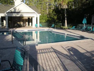 a swimming pool in front of a house at True Happiness, Housing Near Disney Word in Kissimmee