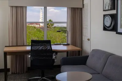 a room with a desk and a chair and a window at Residence Inn Orlando Convention Center in Orlando