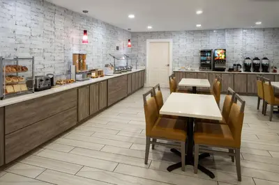 a restaurant with a table and chairs and a counter at Residence Inn Orlando Convention Center in Orlando