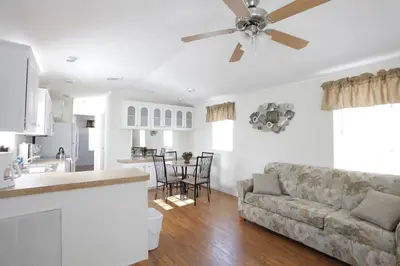 a living room with a couch and a ceiling fan at Sherwood Forest Cottage 6 in Kissimmee