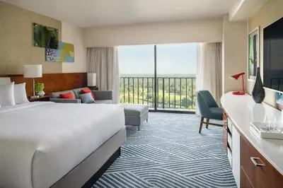a hotel room with a bed and a large window at Hyatt Regency Grand Cypress Resort - Free Shuttle to Theme Parks! in Orlando