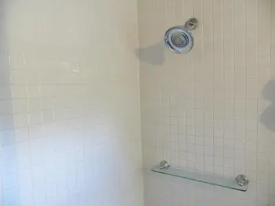 a shower with a glass shelf in a bathroom at The EO Inn - Downtown Orlando in Orlando