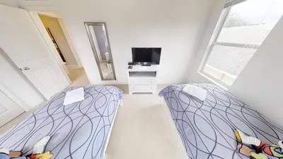 two beds in a small room with a mirror at Crystal Cove 4 Bedroom Vacation Home 1527 in Kissimmee