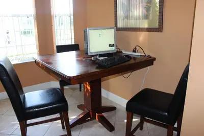 a desk with a computer on it with two chairs at Crystal Cove 4 Bedroom Vacation Home 1527 in Kissimmee