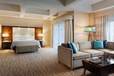 a hotel room with a bed and a couch at Renaissance Orlando at SeaWorld® in Orlando