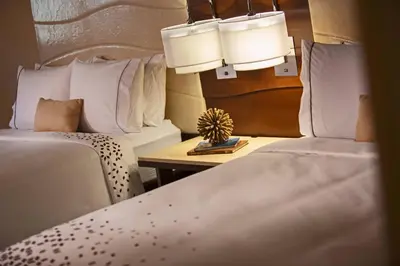 a hotel room with two beds and a table at Renaissance Orlando at SeaWorld® in Orlando