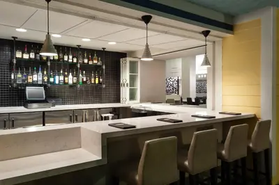 a bar in a restaurant with chairs and a counter at Residence Inn by Marriott Orlando at SeaWorld in Orlando