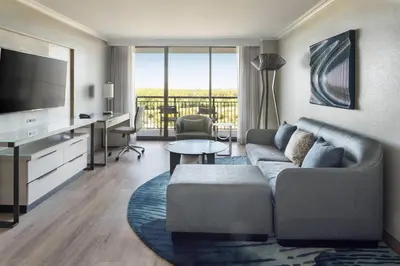 a living room with a couch and a television at Orlando World Center Marriott in Orlando