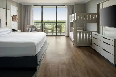 a bedroom with a bed and bunk beds and a balcony at Orlando World Center Marriott in Orlando