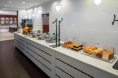 a buffet line with bread and pastries on it at SpringHill Suites by Marriott Orlando Convention Center in Orlando
