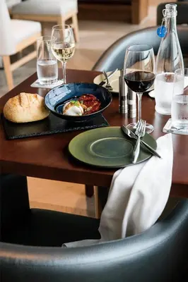 a table with a plate of food and glasses of wine at Hyatt Regency Orlando International Airport Hotel in Orlando