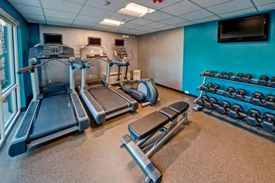 a gym with cardio equipment in a room at Fairfield Inn and Suites by Marriott Orlando Near Universal Orlando in Orlando