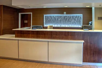 a lobby with a reception desk with a counter top at Fairfield Inn and Suites by Marriott Orlando Near Universal Orlando in Orlando