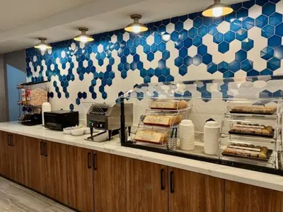 a buffet line in a restaurant with blue and white tiles at La Quinta Inn by Wyndham Orlando International Drive North in Orlando