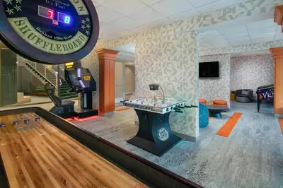 a bowling alley with a table in the middle of a room at Hotel Landy Orlando Universal Blvd, a Tribute Portfolio Hotel in Orlando