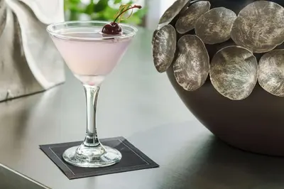 a martini glass on a table with a cherry on top at Hyatt Place Orlando / I-Drive / Convention Center in Orlando