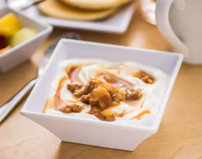 a white bowl of food with nuts on a table at Hyatt Place Orlando / I-Drive / Convention Center in Orlando