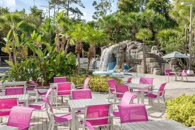 a group of tables and chairs with a fountain at Crowne Plaza Orlando - Lake Buena Vista by IHG in Orlando