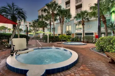 a hot tub in front of a building with palm trees at Holiday Inn Resort Orlando - Lake Buena Vista by IHG in Orlando