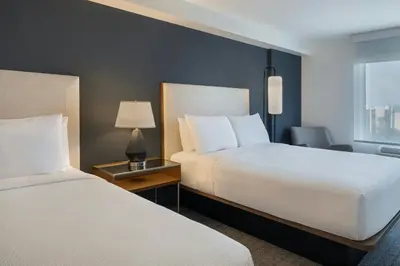 a hotel room with two beds and a window at Courtyard by Marriott across Universal Orlando in Orlando