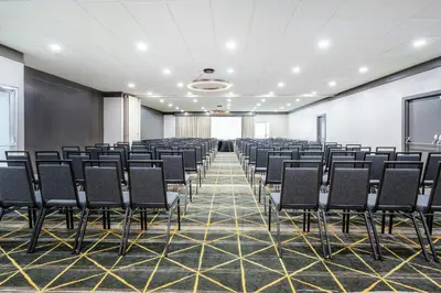 a room with a bunch of chairs in it at Courtyard by Marriott across Universal Orlando in Orlando