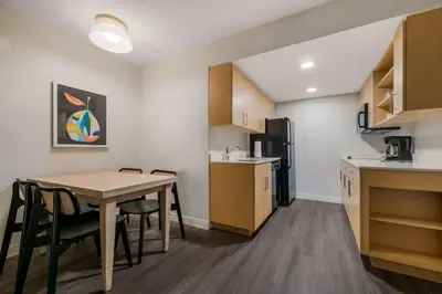 a kitchen and dining room with a table and chairs at Sonesta ES Suites Orlando International Drive in Orlando