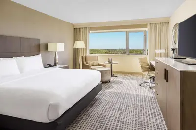 a hotel room with a large bed and a large window at DoubleTree by Hilton Orlando Airport Hotel in Orlando