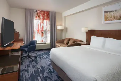 a hotel room with a bed and a desk and a television at Fairfield Inn & Suites by Marriott Orlando International Drive/Convention Center in Orlando