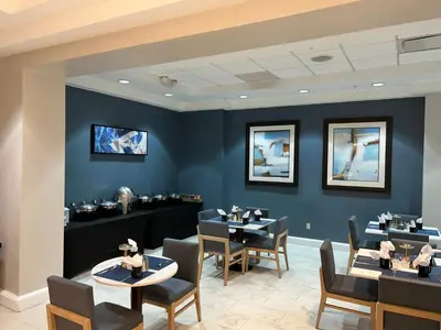 a dining room with blue walls and tables and chairs at Crowne Plaza Orlando-Downtown by IHG in Orlando