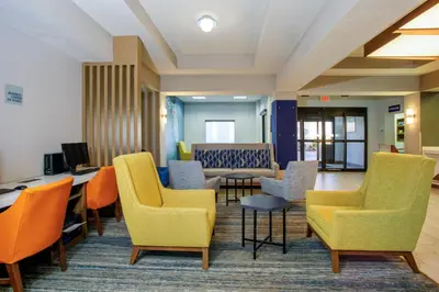 a waiting room with chairs and a table at Holiday Inn Express Orlando-Ocoee East by IHG in Orlando