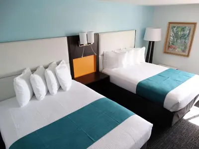 a hotel room with two beds in a room at Best Western Plus Orlando Lake Buena Vista South Inn & Suites in Kissimmee