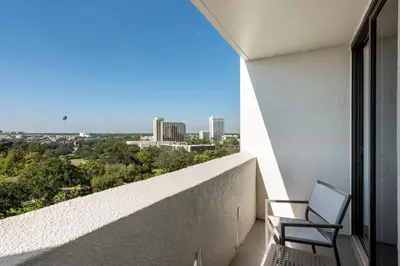 a balcony with a chair and a view of a city at Holiday Inn Orlando – Disney Springs® Area by IHG in Orlando