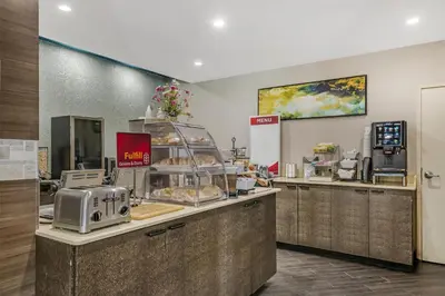 a bakery with a counter with pastries on it at Best Western Plus Sanford Airport/Lake Mary Hotel in Sanford
