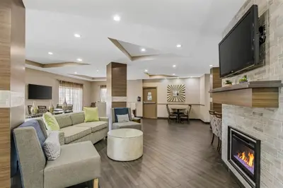a lobby with a living room with a fireplace at Best Western Plus Sanford Airport/Lake Mary Hotel in Sanford