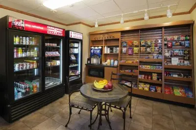 a store with a table and chairs in a room at Candlewood Suites Lake Mary by IHG in Lake Mary