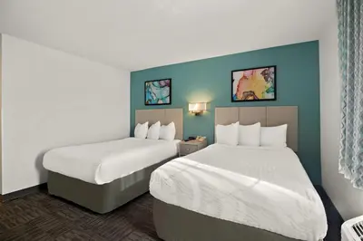 a hotel room with two beds and blue walls at MainStay Suites Orlando Altamonte Springs in Orlando